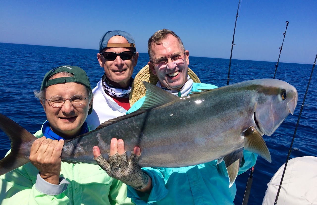 Three friends displaying their catch
