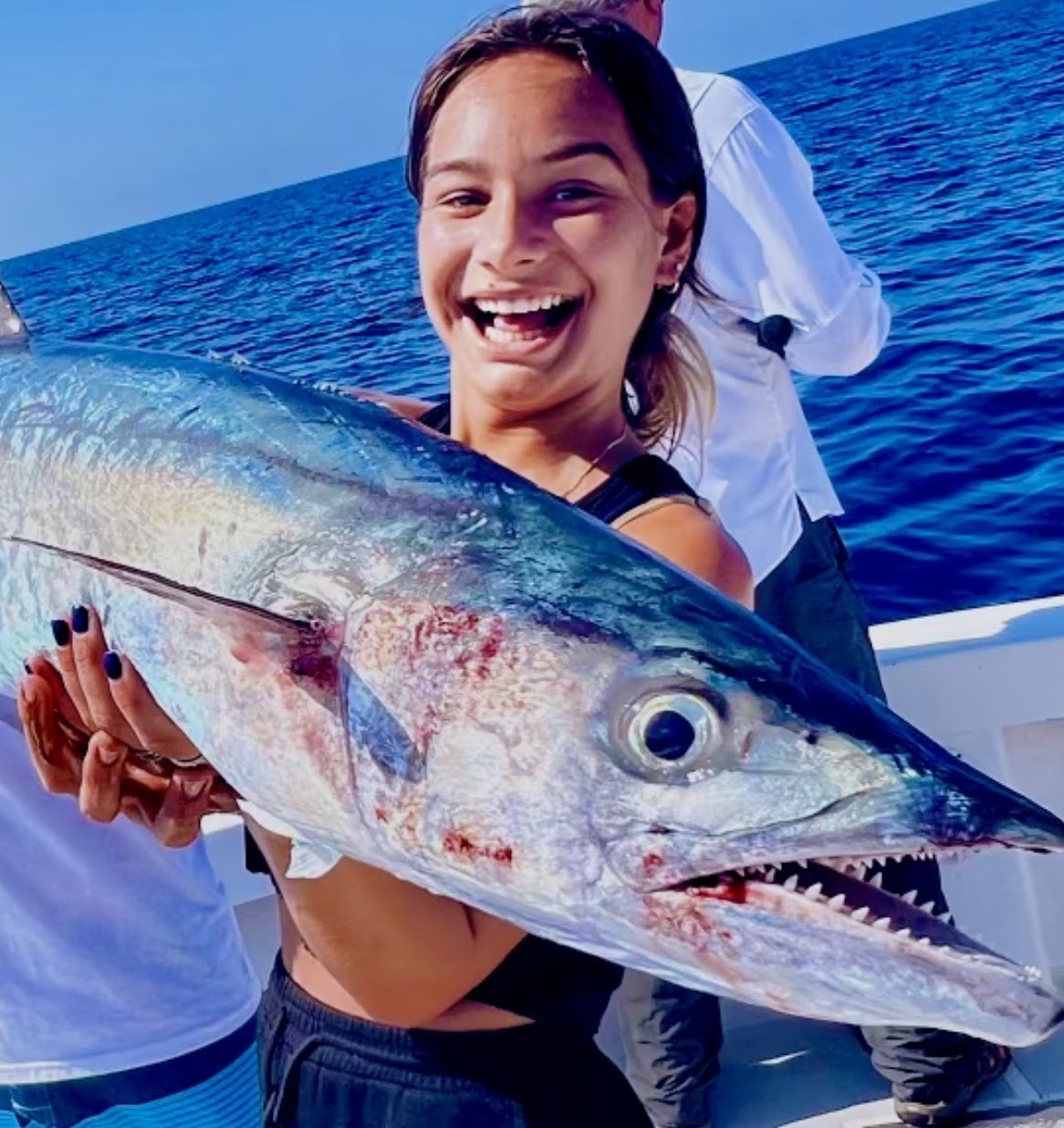 A smiling angler with her catch