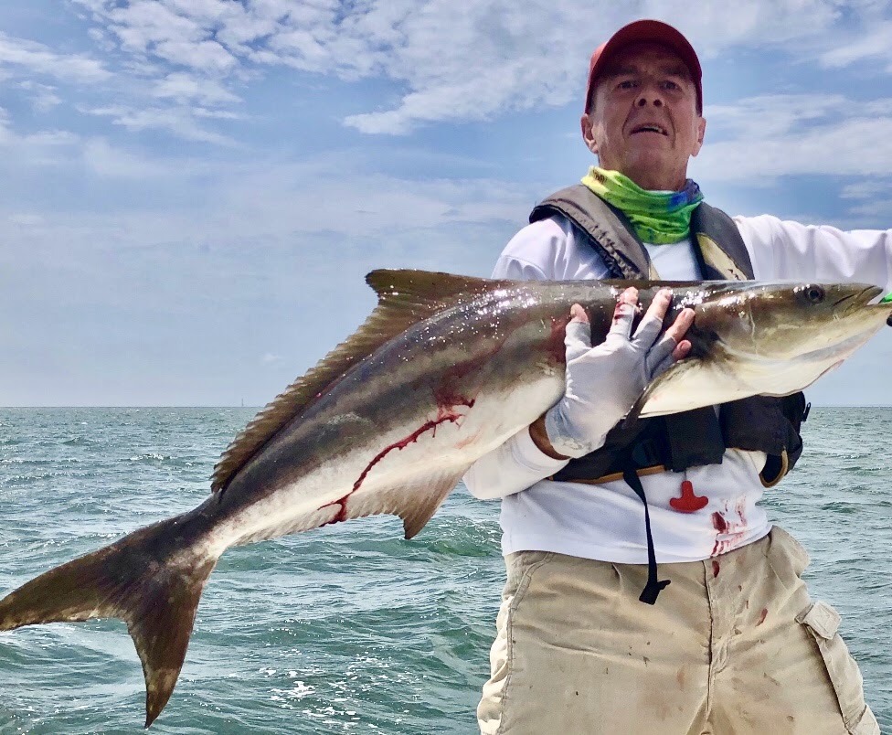An angler displaying a fish on deck