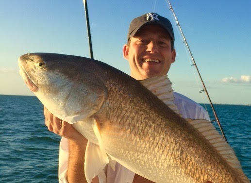 An angler displaying a large fish