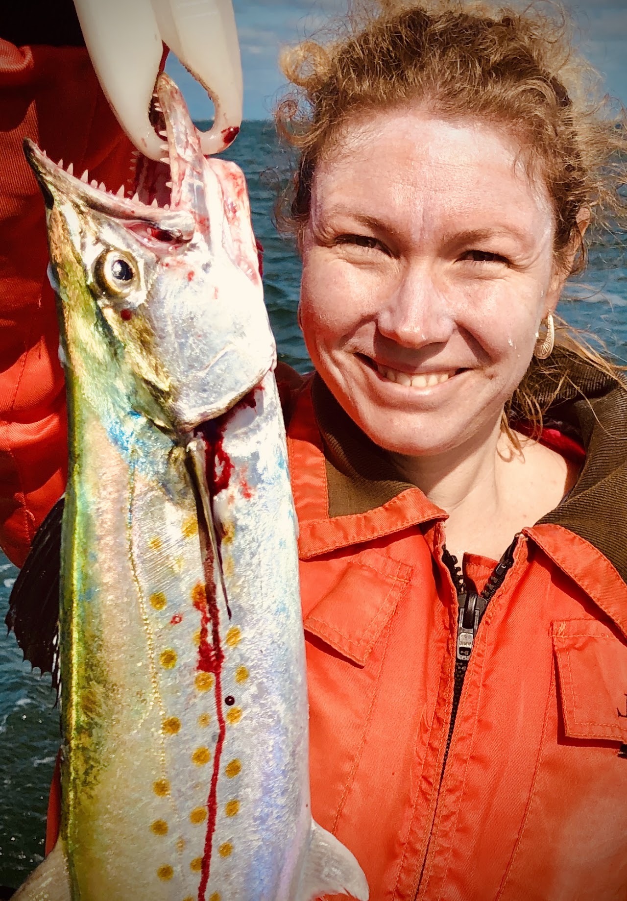 An angler in a red shirt with his catch